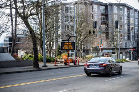 Seattle, WA USA - circa April 2022: Angled view of a road sign pointing the direction of the Climate Change Arena parking garageのeditorial素材
