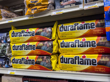 Woodinville, WA USA - circa May 2022: Angled view of indoor fire logs for sale inside a Haggen grocery store.のeditorial素材