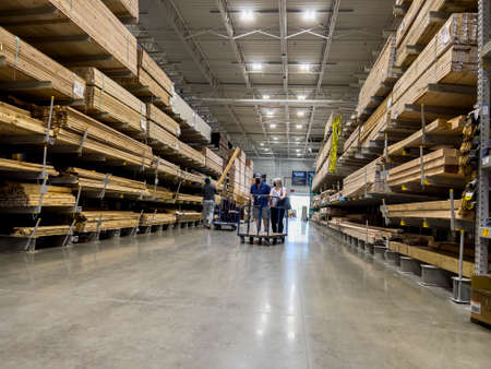 Mill Creek, WA USA - circa June 2022: View of a couple shopping for lumber inside a Lowe's home improvement store.のeditorial素材