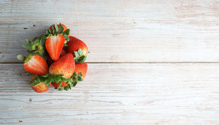 Fresh organic strawberry on top of wooden table