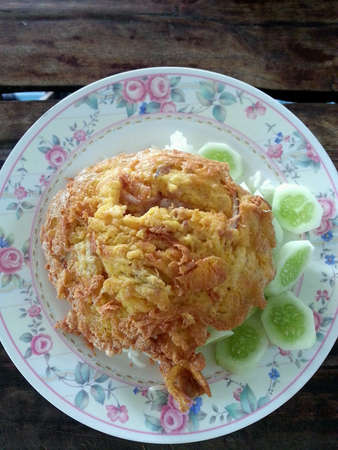 Steam rice with fried egg on top.の素材