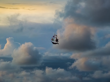 Boat Kite Sailing in The Stormy and Cloudy Sky To Bright Futureの写真素材