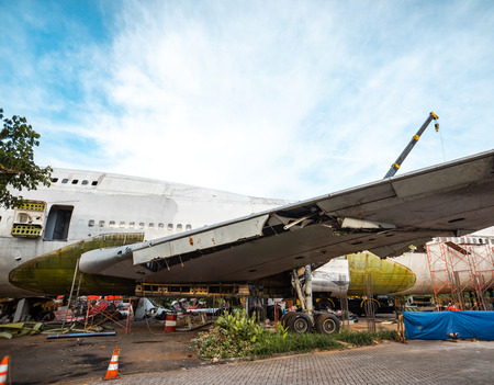 Old Big Aircraft or Plane Being Scrapped and Taken Apart To Its Metal Part. Airplane Being Disassemble in Junk Yard.の写真素材