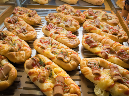 Grill Sausage Bread with Tomato and Cheese Souce. Sousages Boat Snack on Display at Bread Storeの写真素材