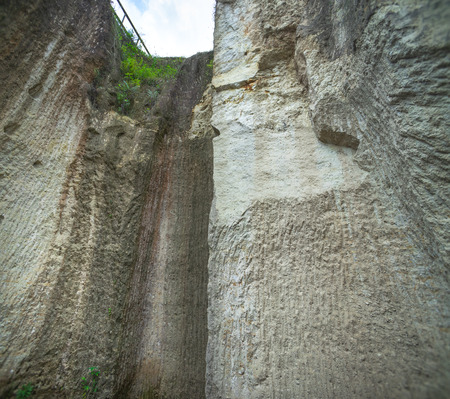 Stone Cliff. Hard Surface Rock Looking Up To Its Crest From The Bottom of The Cliff. Reaching Higher Goal That Bigger Than Ourself in Front of Obstacle.の写真素材