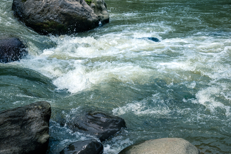 Wild River Water Stream Between Big Granite Rock. Rivulet Water Flowing Rushing By Big Stone Boulder.の写真素材