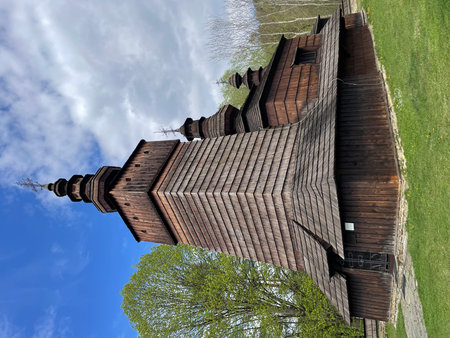 Wooden church in green nature in sunny weather. The wooden church of Saint Paraskieva in the village of Potoky was built in 1773.の写真素材