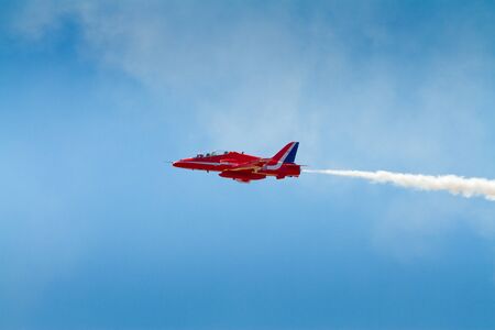 Red Arrows plane Weston-super-Mare, Somerset, England-July 23, 2012 appearing at the Grand Pier Airshowのeditorial素材
