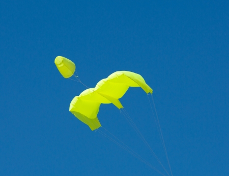 Colourful kite against vibrant blue skyの写真素材