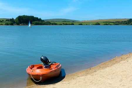 Boat and blue water lake Siblyback near Liskeard Bodmin Moor Cornwall England UK の写真素材