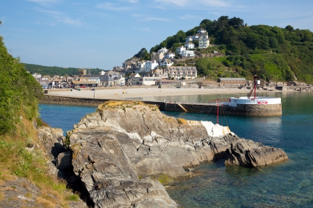 Looe harbour and beach Cornwall with blue sea and sky in this beautiful coastal town 