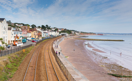 Dawlish Devon England with beach railway track and sea on blue sky summer dayのeditorial素材