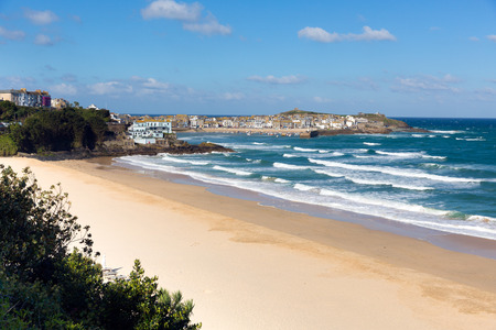 Porthminster beach and St Ives Cornwall white waves and blue sea and sky on a beautiful summer dayの写真素材