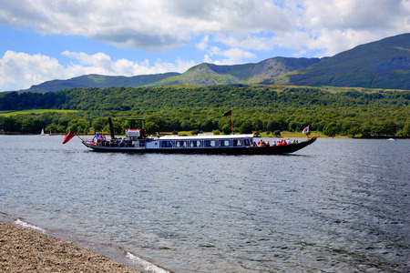 Gondola steam boat on Coniston water Lake District England uk on a beautiful sunny summer day in this popular tourist attractionのeditorial素材