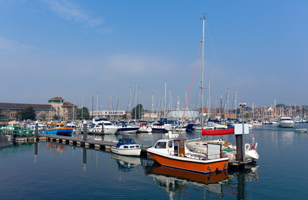 North Quay marina Weymouth Dorset UK with boats and yachts on a calm summer day with blue skyの写真素材