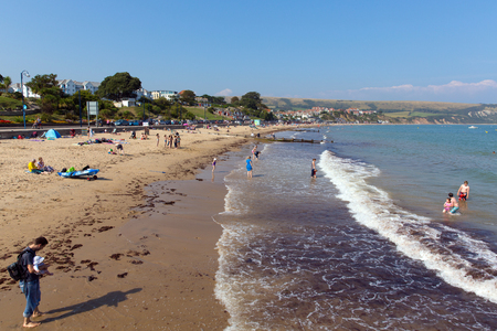 Swanage beach Dorset England UK with waves on the shore near Poole and Bournemouth at the eastern end of the Jurassic Coast a World Heritage Site popular south coast tourist destinationのeditorial素材