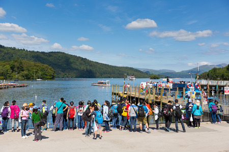 Students tourists and visitors at Bowness on Windermere Lake District Cumbria England UK in summer sun with blue skyのeditorial素材