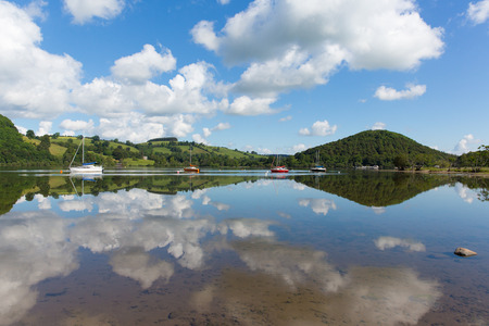 The English Lake District popular beautiful UK holiday destination Ullswater Cumbria North England in summer with boats blue sky and cloud reflectionsのeditorial素材