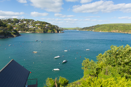 Salcome estuary Devon UK with boats and blue sky and houses on the hillsideの写真素材