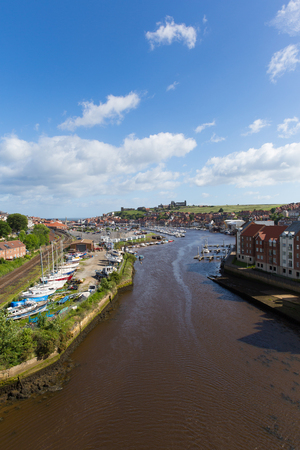 Whitby North Yorkshire England uk seaside town and tourist destination in summer with view of River Esk to Abbey and coastのeditorial素材