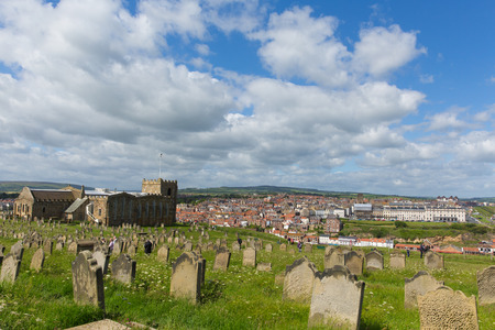 Church next to Whitby Abbey North Yorkshire uk ruins in summer on hillside over tourist town and holiday destinationのeditorial素材