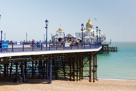 Traditional English pier Eastbourne West Sussex UK busy with visitors in fine spring weatherのeditorial素材