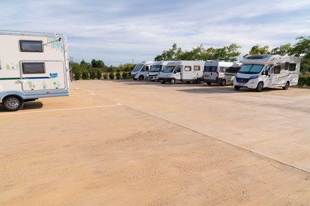 Motorhomes and campervans parked on the Area d`autocaravanes aire in La Selva del Camp, Tarragona Province, Spain using the water and waste services and parkingのeditorial素材