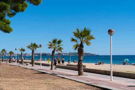 Promenade walk with palm trees from Platja L`Esquirol to Vilafortuny Cambrils Spain Costa Dorada Tarragona Provinceのeditorial素材