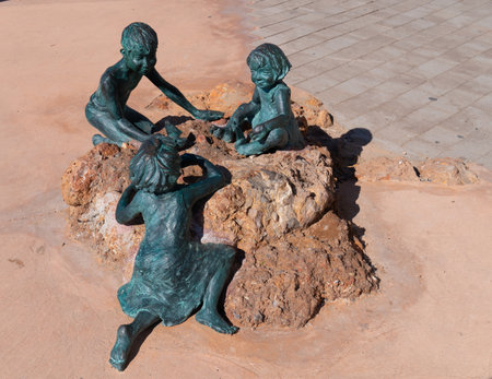 Statue of three children on the beautiful Cami de Ronda coast walk to the east of Salou Costa Dorada Catalonia Spainのeditorial素材