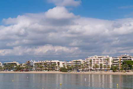 Salou seafront beach of Platja de Ponent with buildings sea and palm trees Costa Dorada Catalonia Spainのeditorial素材
