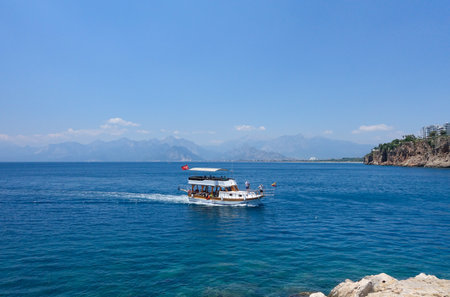 Tourist pleasure boat returning to the marina in historic old town known as Kaleici Antalya, Turkey on Tuesday 20th June 2023のeditorial素材