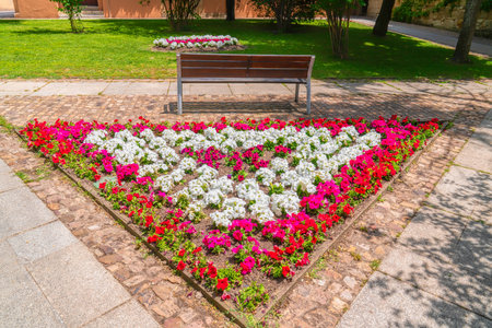 Triangular flower display of red, white and pink flowers in a parkの写真素材