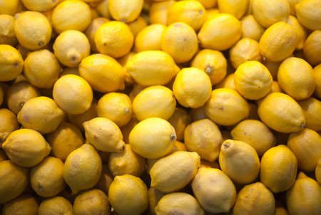 Organic pile of lemons in city marketの写真素材