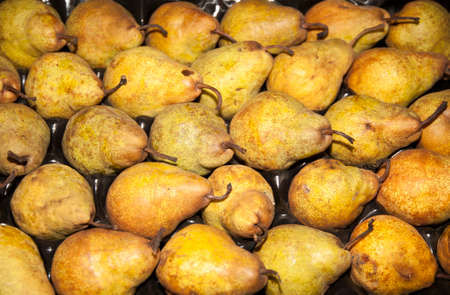 Golden colored pears on retail market asa background