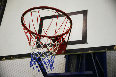 Basketball hoop in a high school gymの写真素材