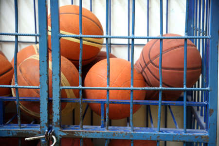 Old rubber basket balls in a school gym like a prisonの写真素材