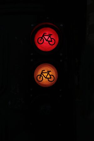 Red and orange colored traffic signs by night in the city