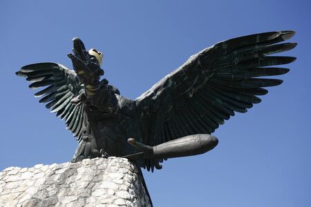 Statue of the famous hungarian legendary Turul bird against blue skyのeditorial素材