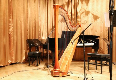 Beautiful golden harp in the auditorium before concertの写真素材