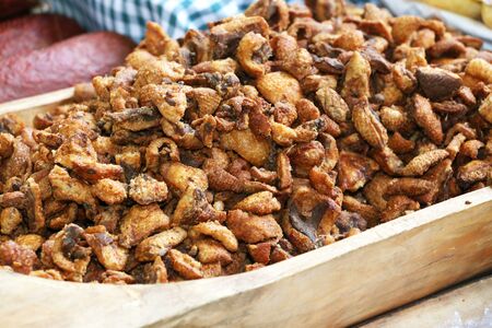 Goose cracklings greaves placed in a traditional vessel from wood carvedの写真素材
