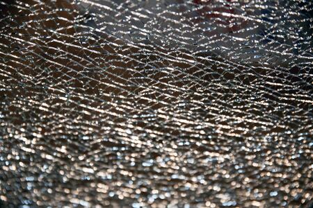 Supposedly unbreakable toughened tempered glass as a backgroundの写真素材