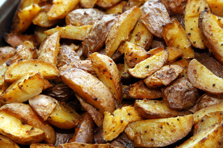 Pan-fried potatoes close up as a backgroundの写真素材