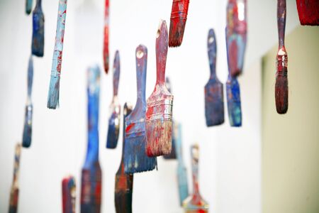 Colorful paint brushes hanging as artistic objectsの写真素材