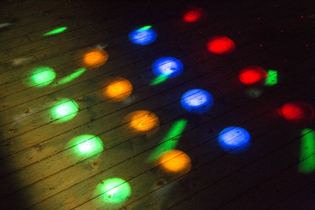 Colorful disco lights on the dance floor at a discotheque without peopleの写真素材