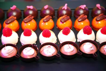 Variety of colorful modern french sweet desserts different fillingsの写真素材