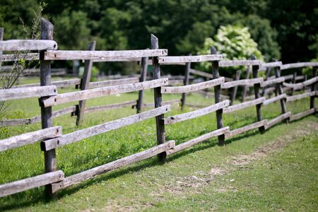 Old wooden corral fence in meadow rural scene bokeh moodの写真素材