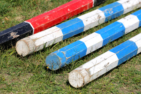 Multi colored image of show jumping poles at the show jumping arena. Wooden barriers for jumping horses as a backgroundの写真素材