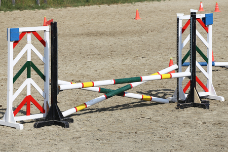 Multi colored image of show jumping poles at the show jumping arena. Wooden barriers for jumping horses as a backgroundの写真素材