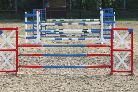 Multi colored image of show jumping poles at the show jumping arena. Wooden barriers for jumping horses as a backgroundの写真素材