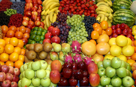 Background from freshly picked apples, pears, bananas, grapes, strawberries, cranberries, lemons, melons, raspberries, currants, blackberries, peaches, gooseberries, apricots, peachesの写真素材